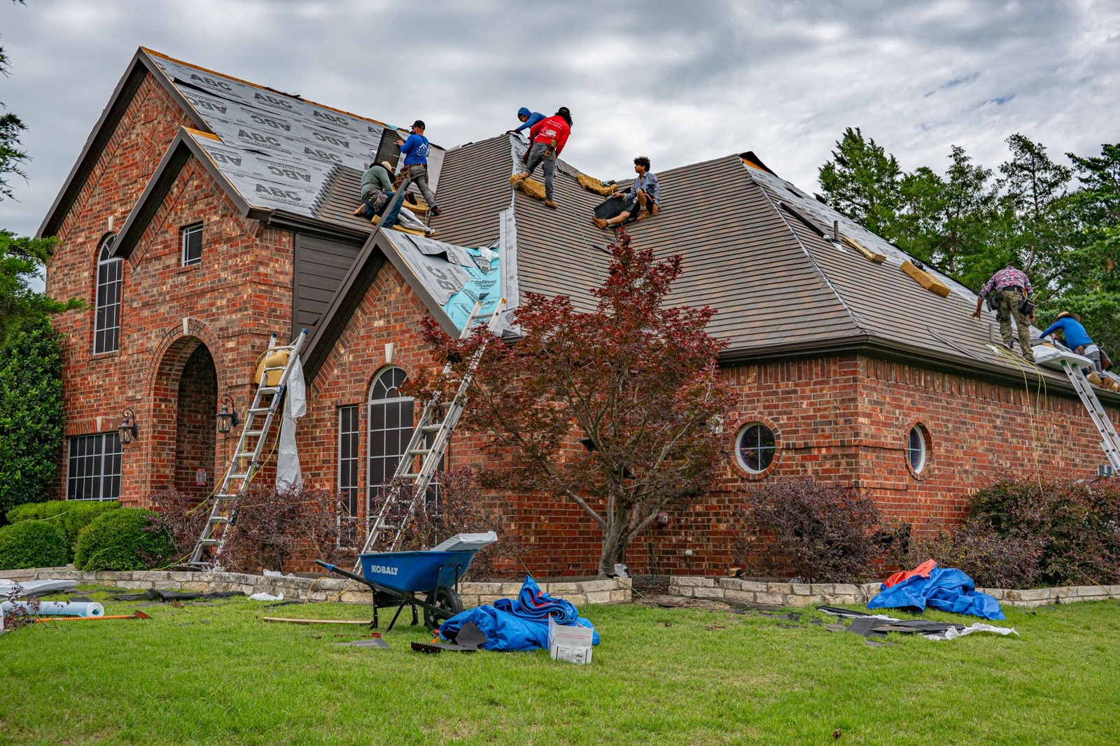 A roofing crew working on a residential home